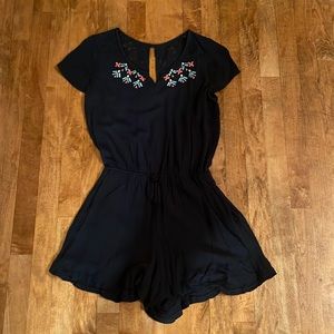 Abercrombie navy blue romper with florar embroidery on top.